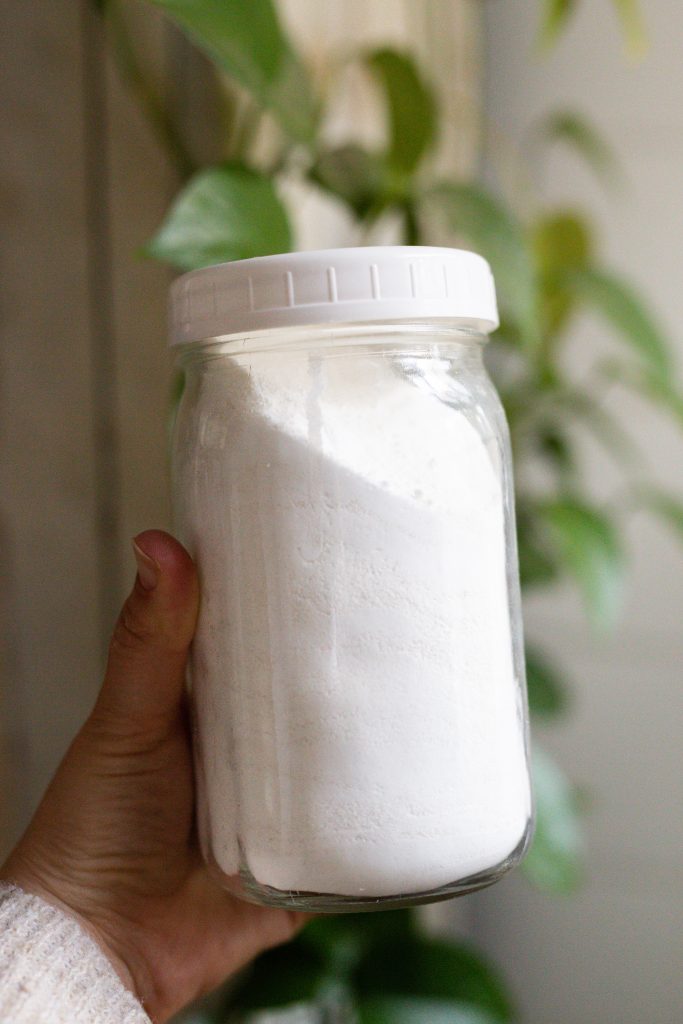 powdered laundry detergent in a mason jar with white lid